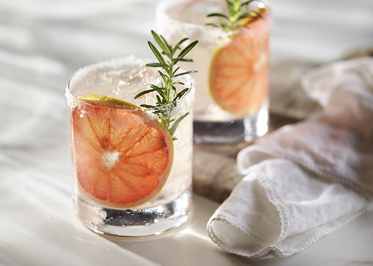 Paloma cocktail in Collins Glass, from tequila with grapefruit juice,  decorated with a slice of grapefruit and rosemary.Whiskey in rocks glass  with i Stock Photo - Alamy